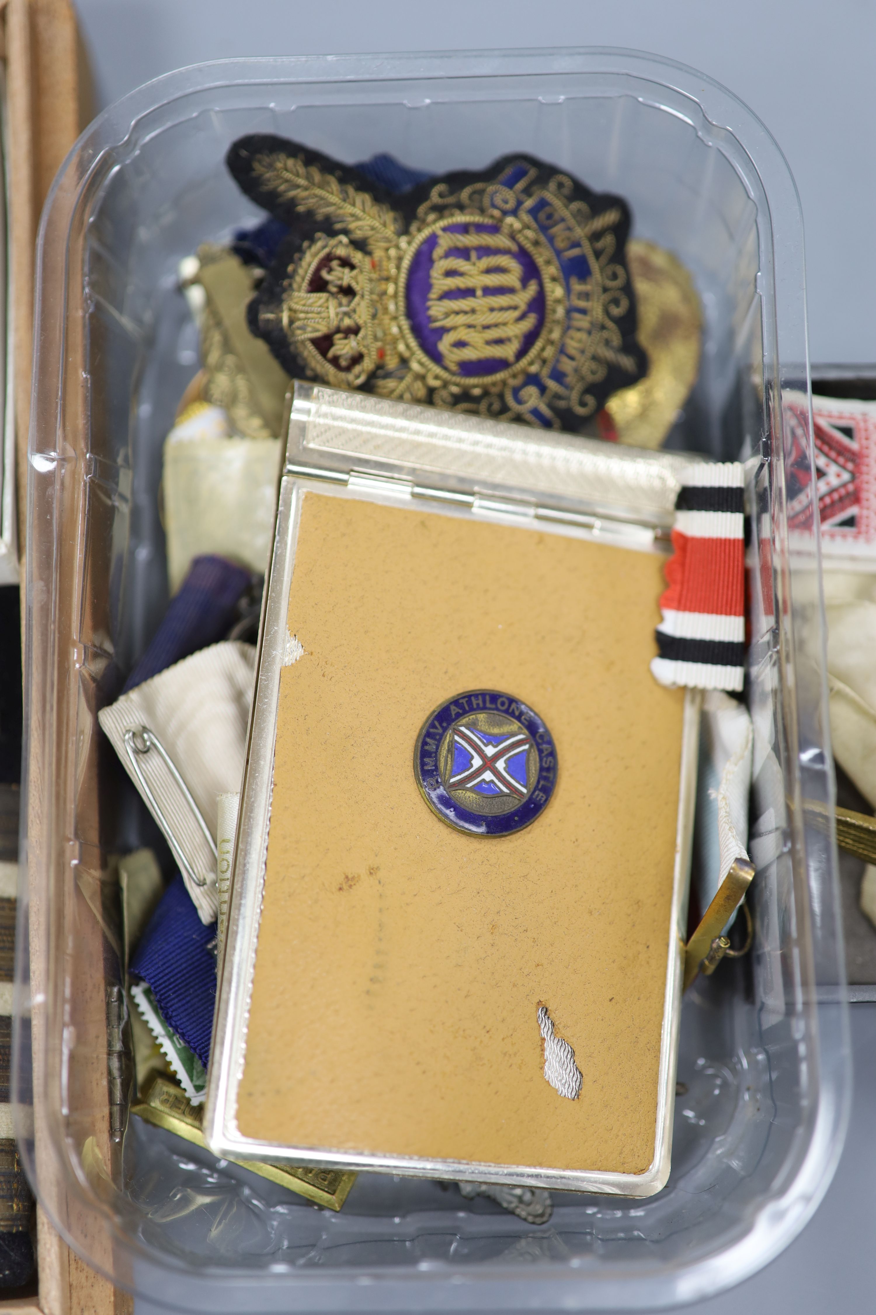 A collection of military medals, badges, coins etc.